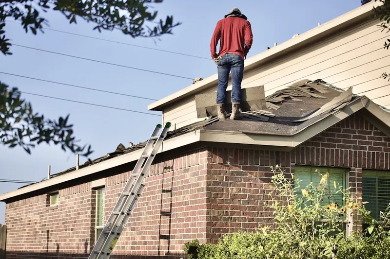 Professional roofer working on a residential roof in Belli Ranch